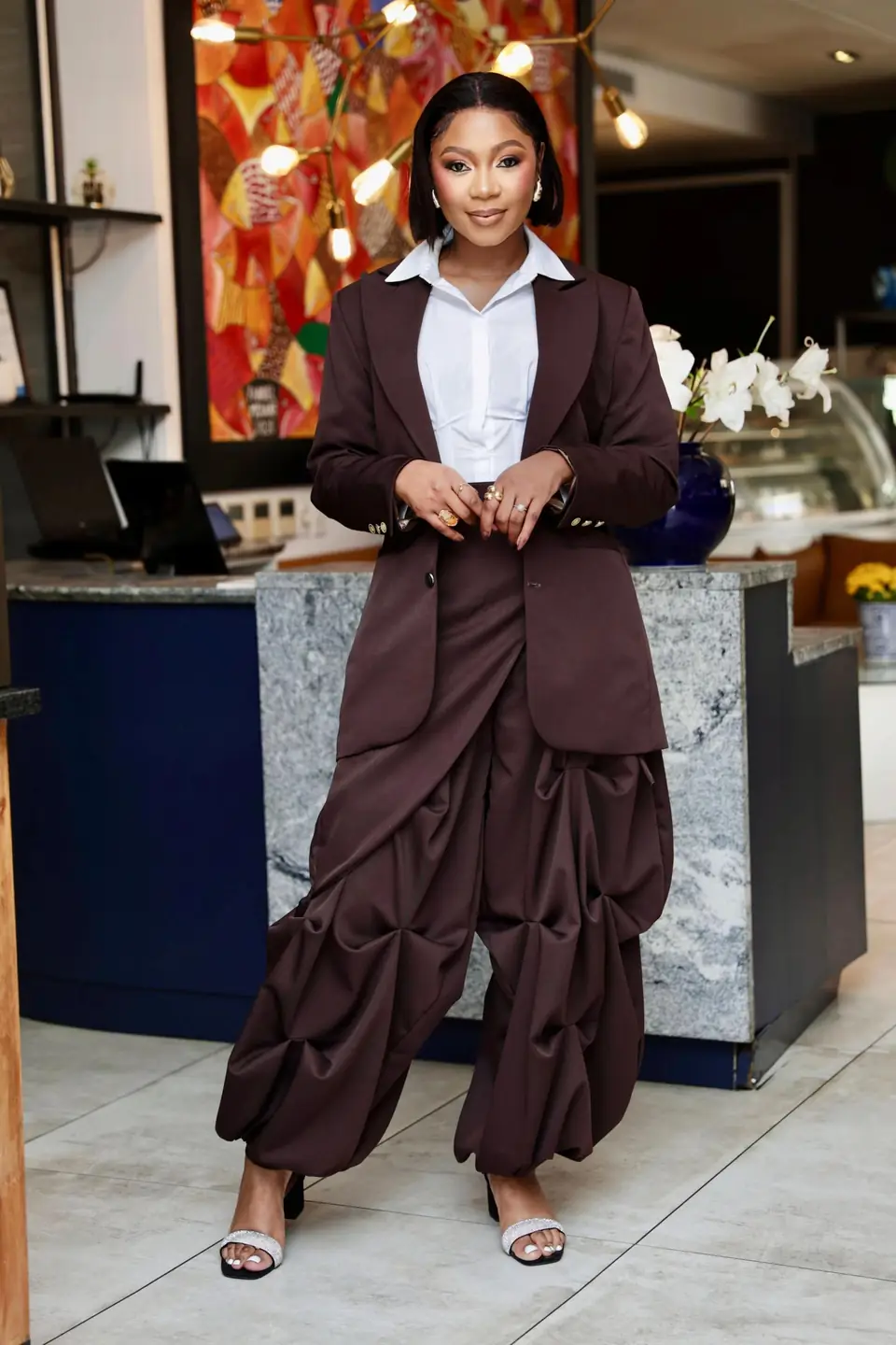 Oversized chocolate blazer worn over ruched trousers