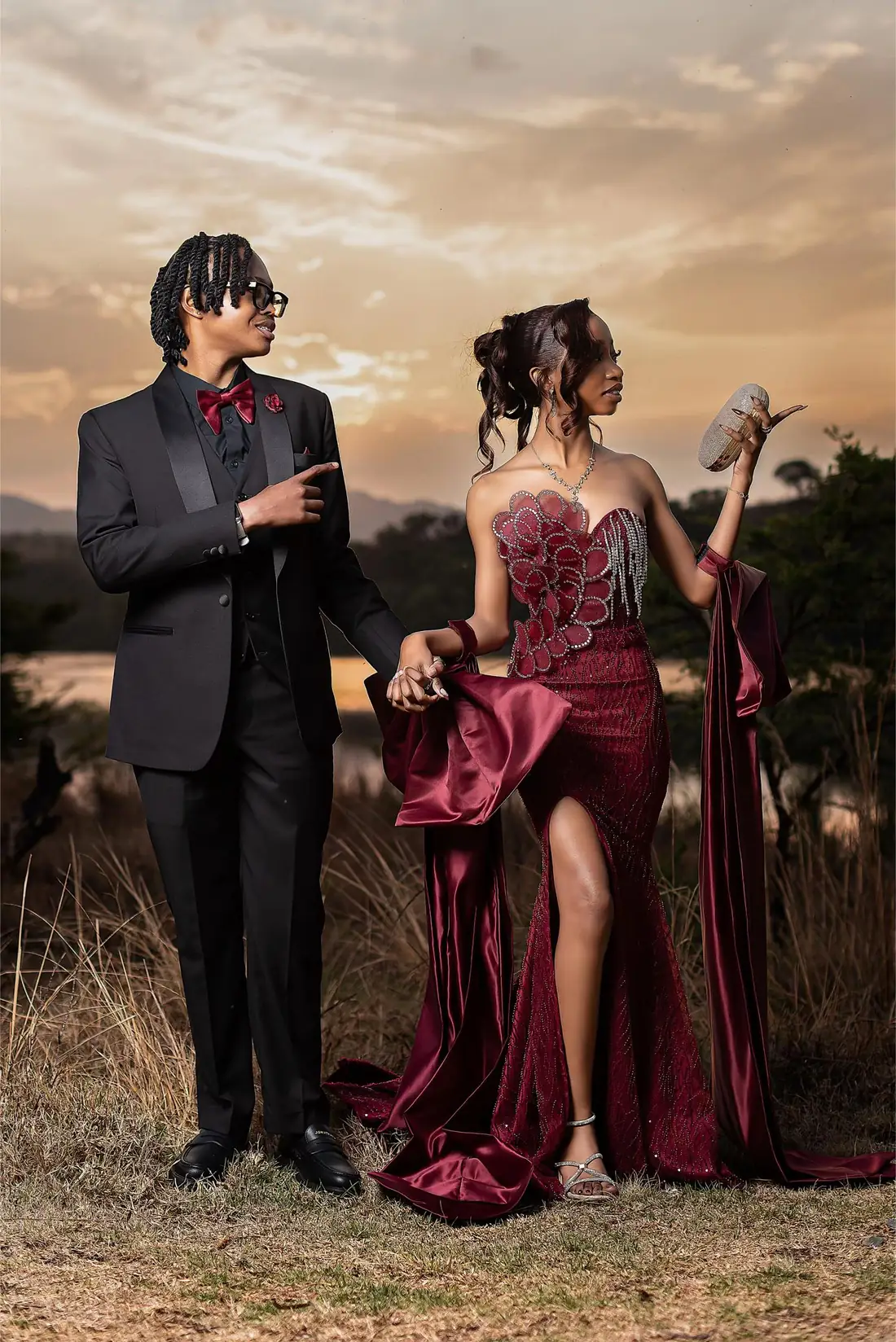 A matric dance couple in a burgundy sequin gown and black tuxedo