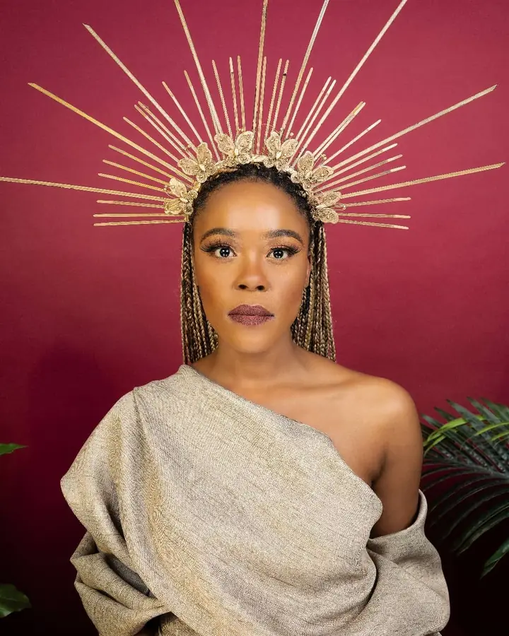 Portrait in a draped neutral wrap and a gold sunburst crown