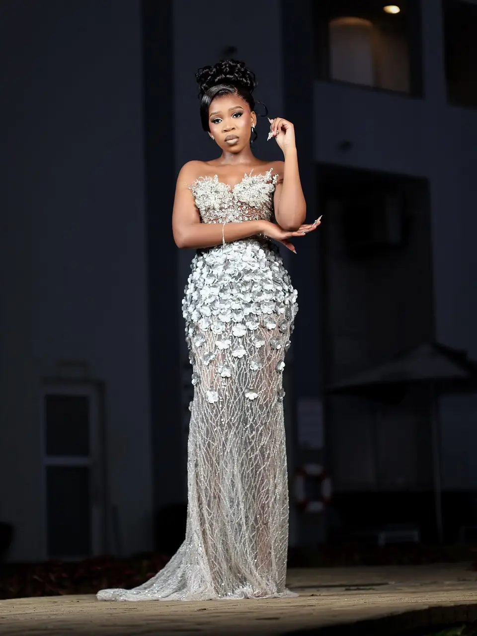 A client in her finished gown, covered in hand-applied floral embellishment