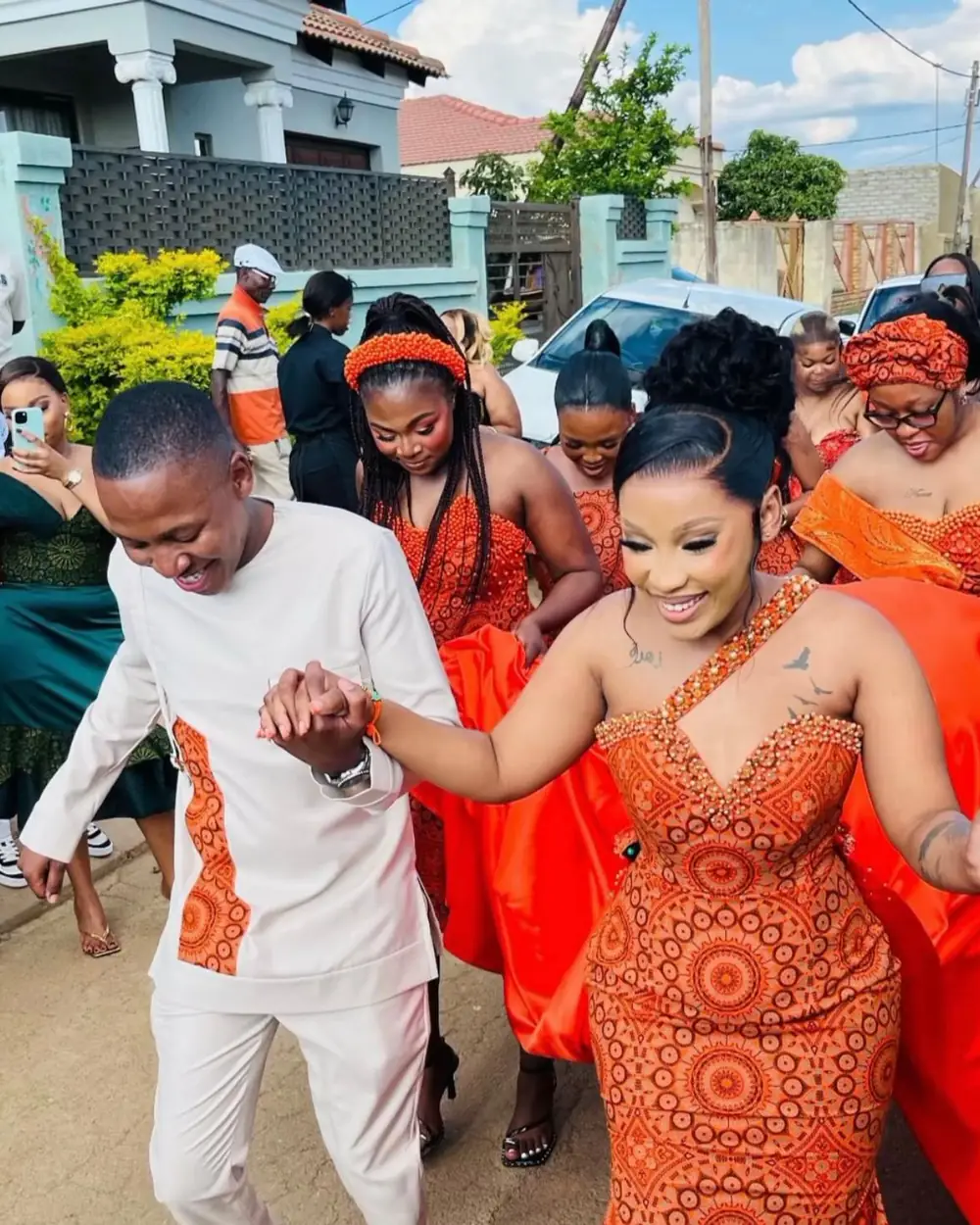 A couple dancing at their traditional wedding in coordinated attire