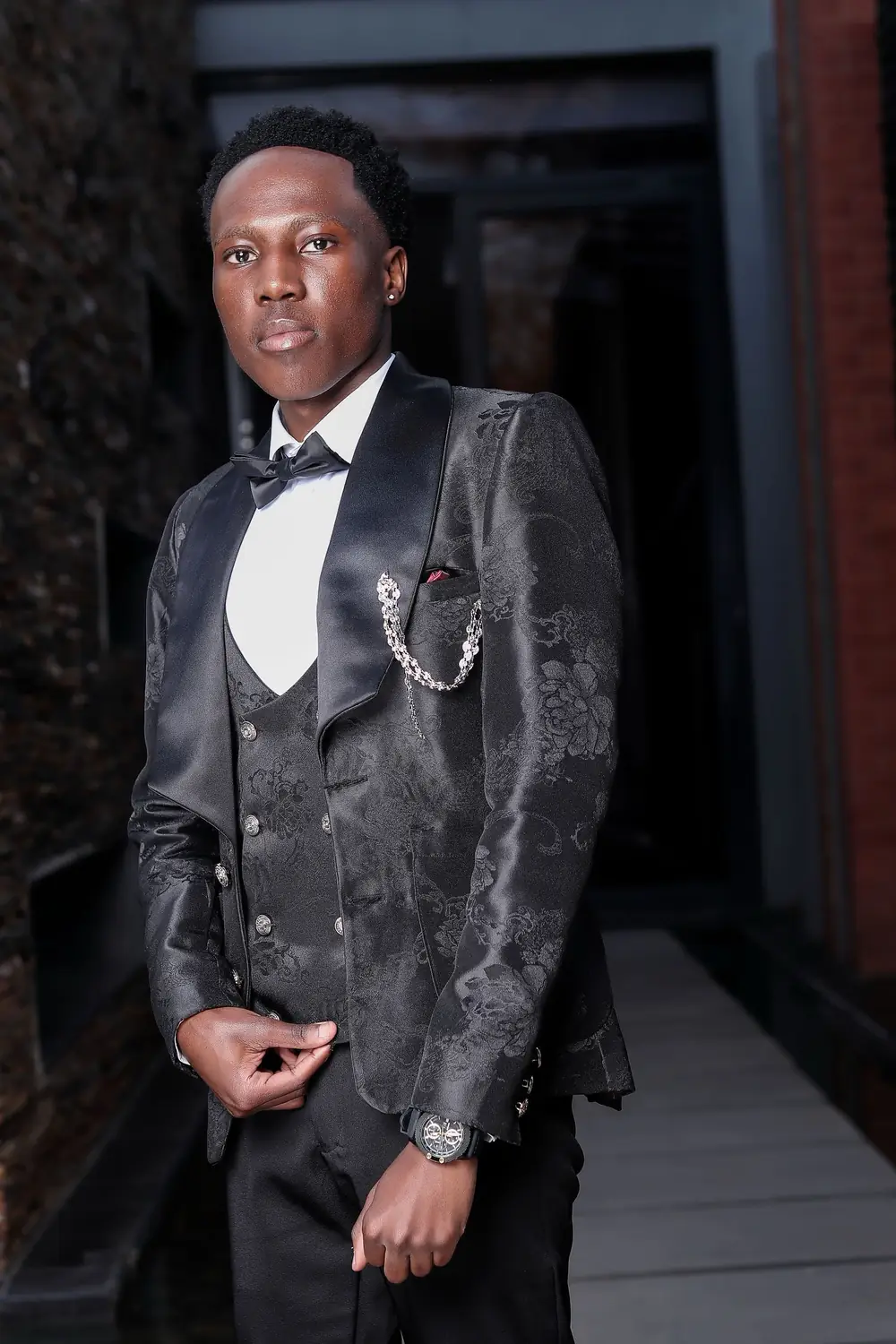 A client in a black jacquard dinner jacket and waistcoat