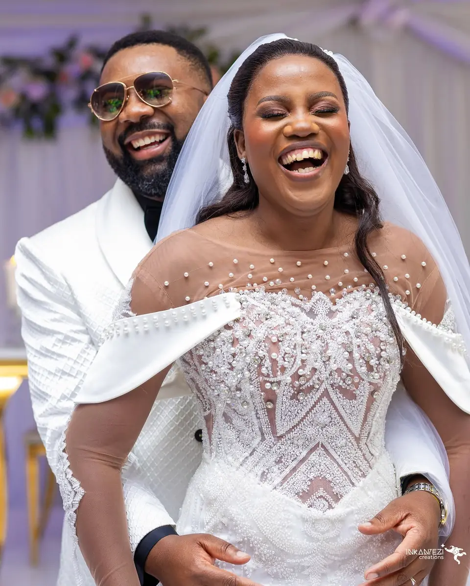 A bride and groom laughing together on their wedding day